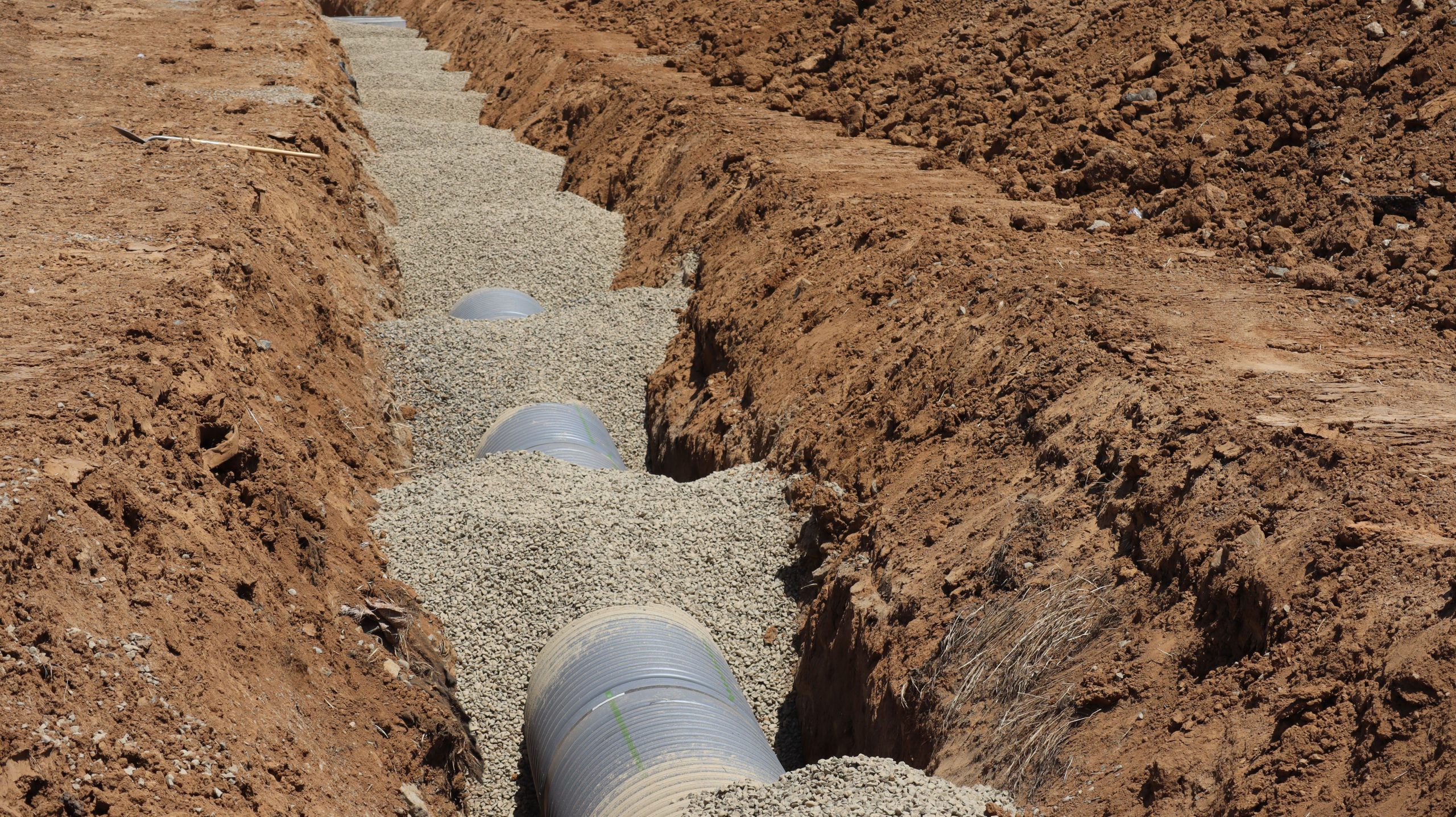 Services Detailed view of drainage pipe construction in a trench, Elk Grove, California.